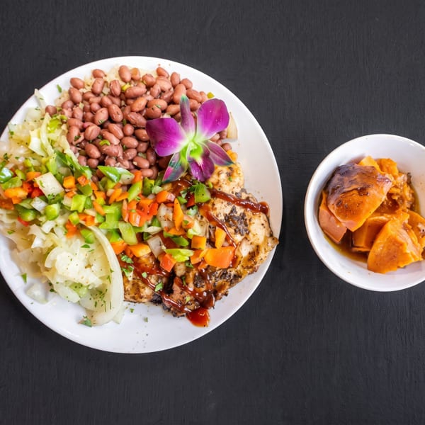 Grilled chicken with beans, cabbage, salsa, and a side of sweet potatoes.